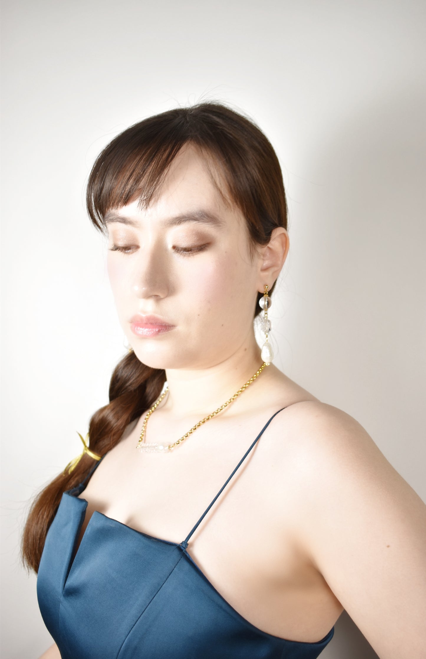 Woman wearing a blue dress with a plain background