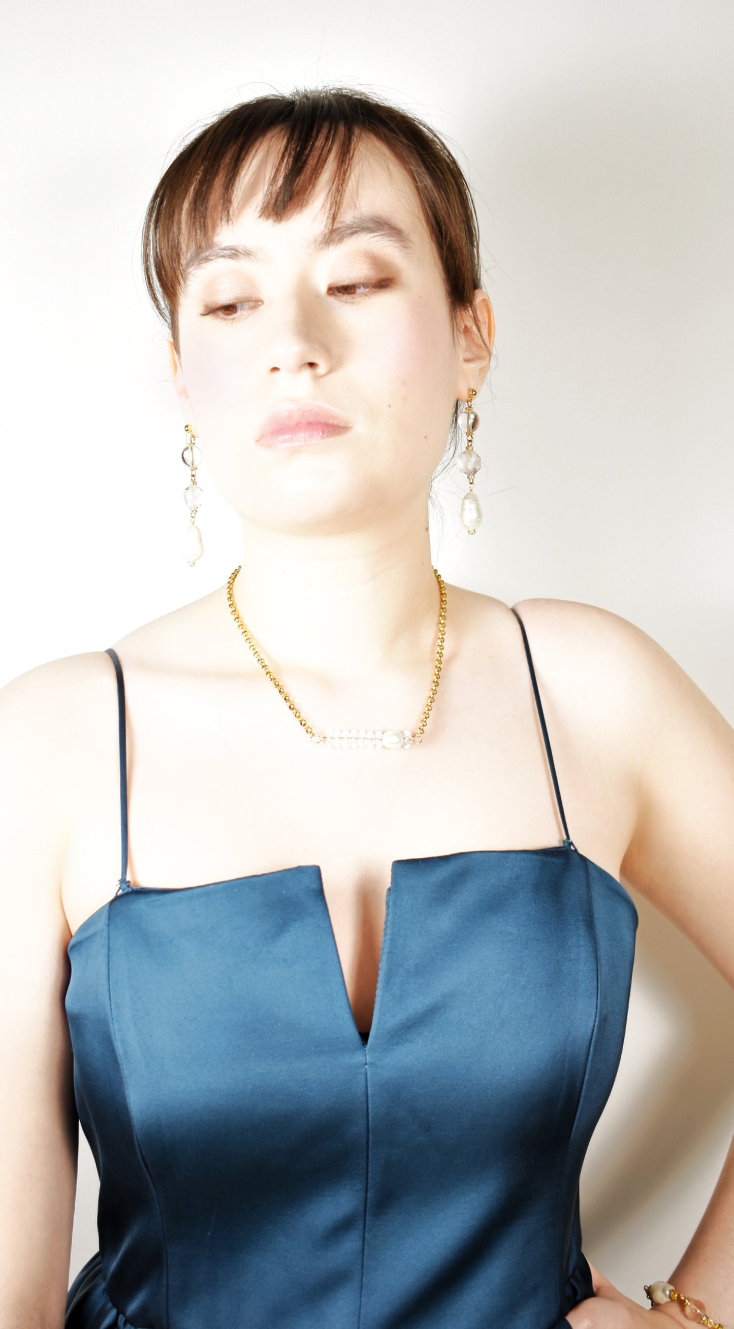 Woman wearing a blue dress with a plain background
