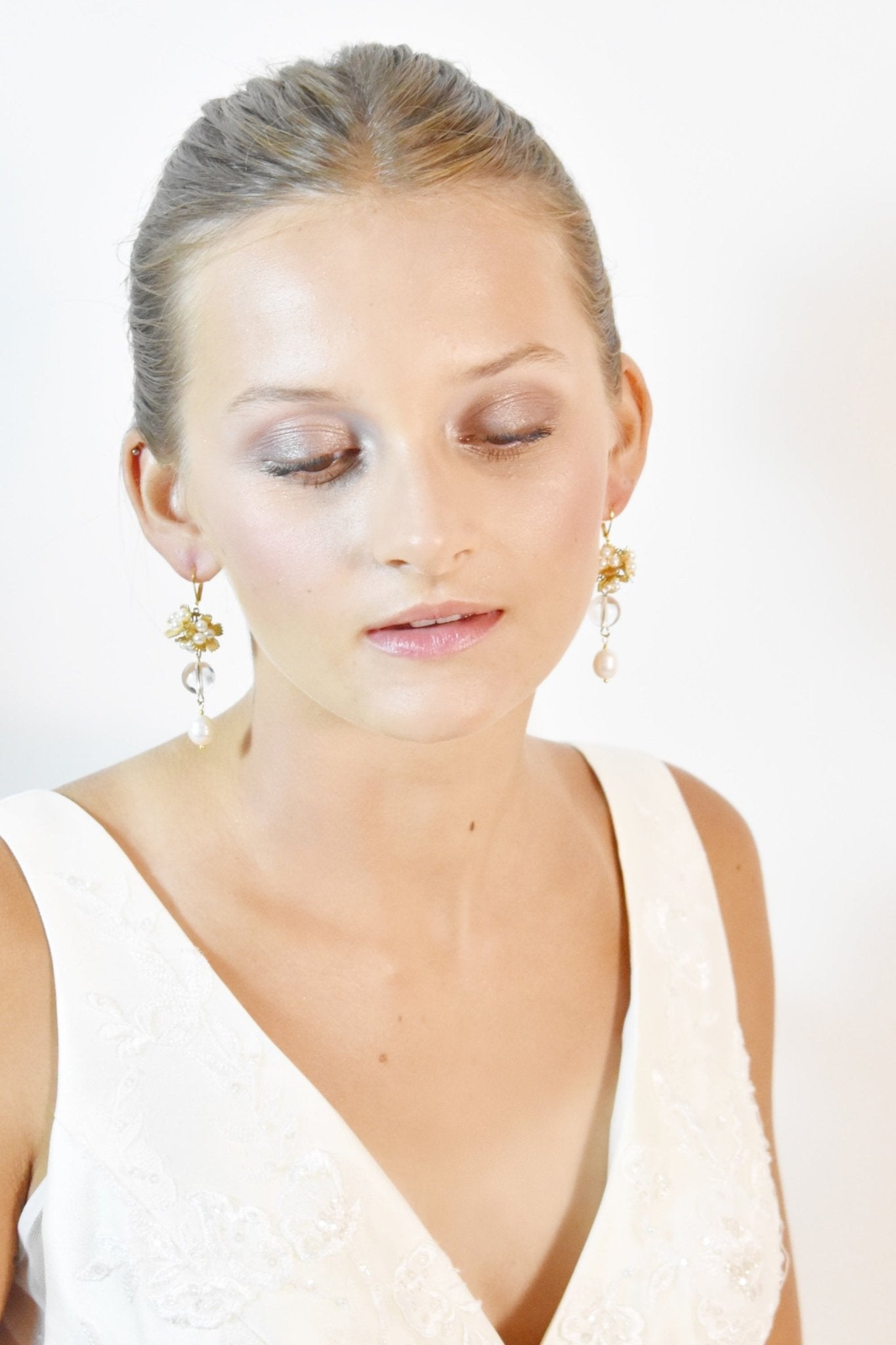 Woman wearing a white dress with a plain background