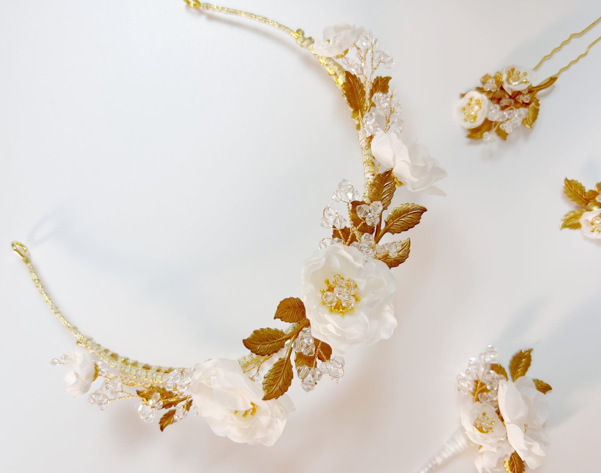Floral headband with gold accents on a light gray background