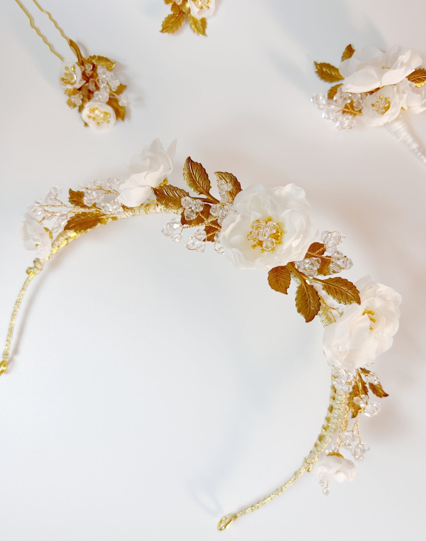 Floral headband with gold accents on a light gray background