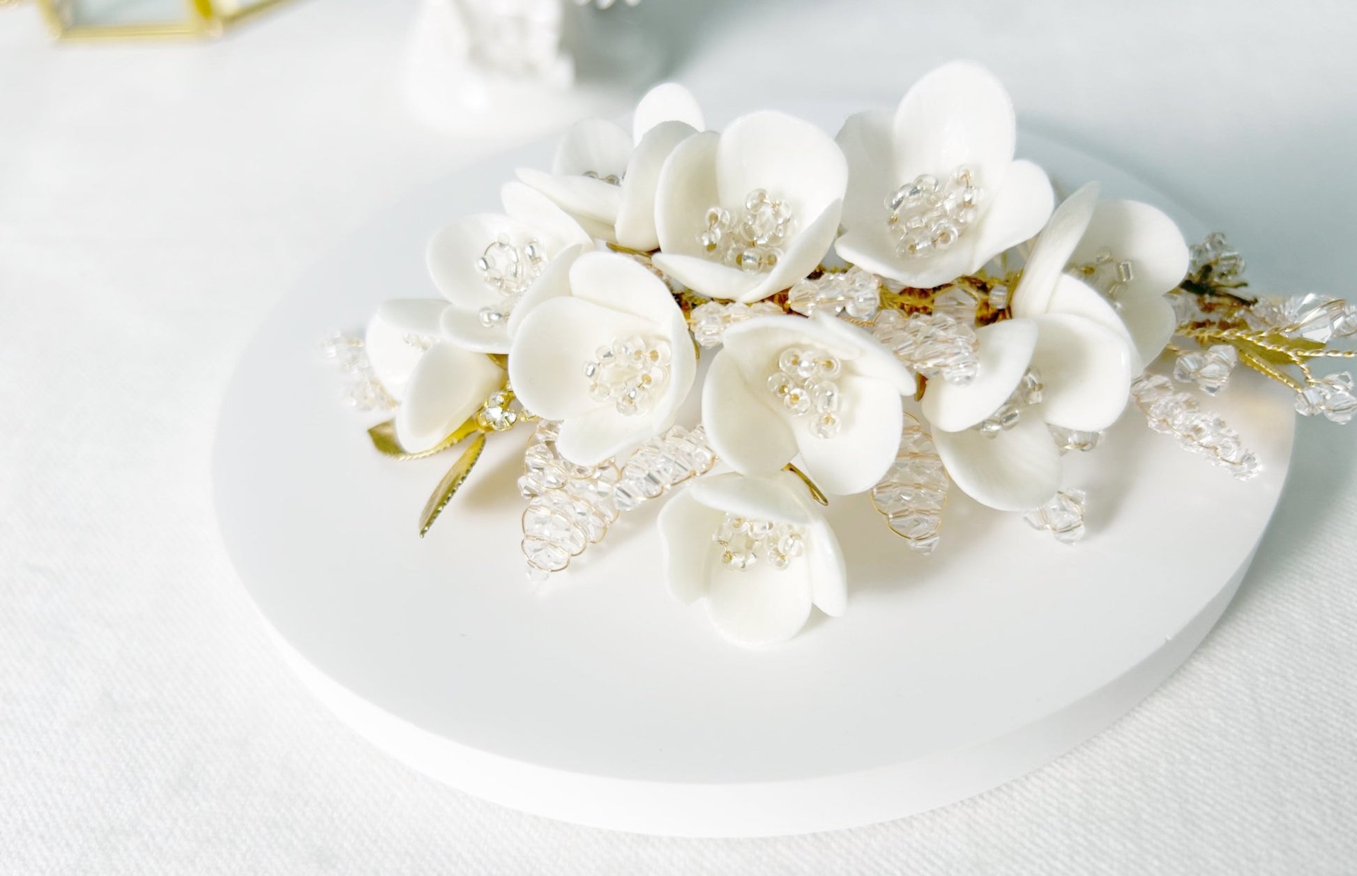White floral hair accessory on a white plate