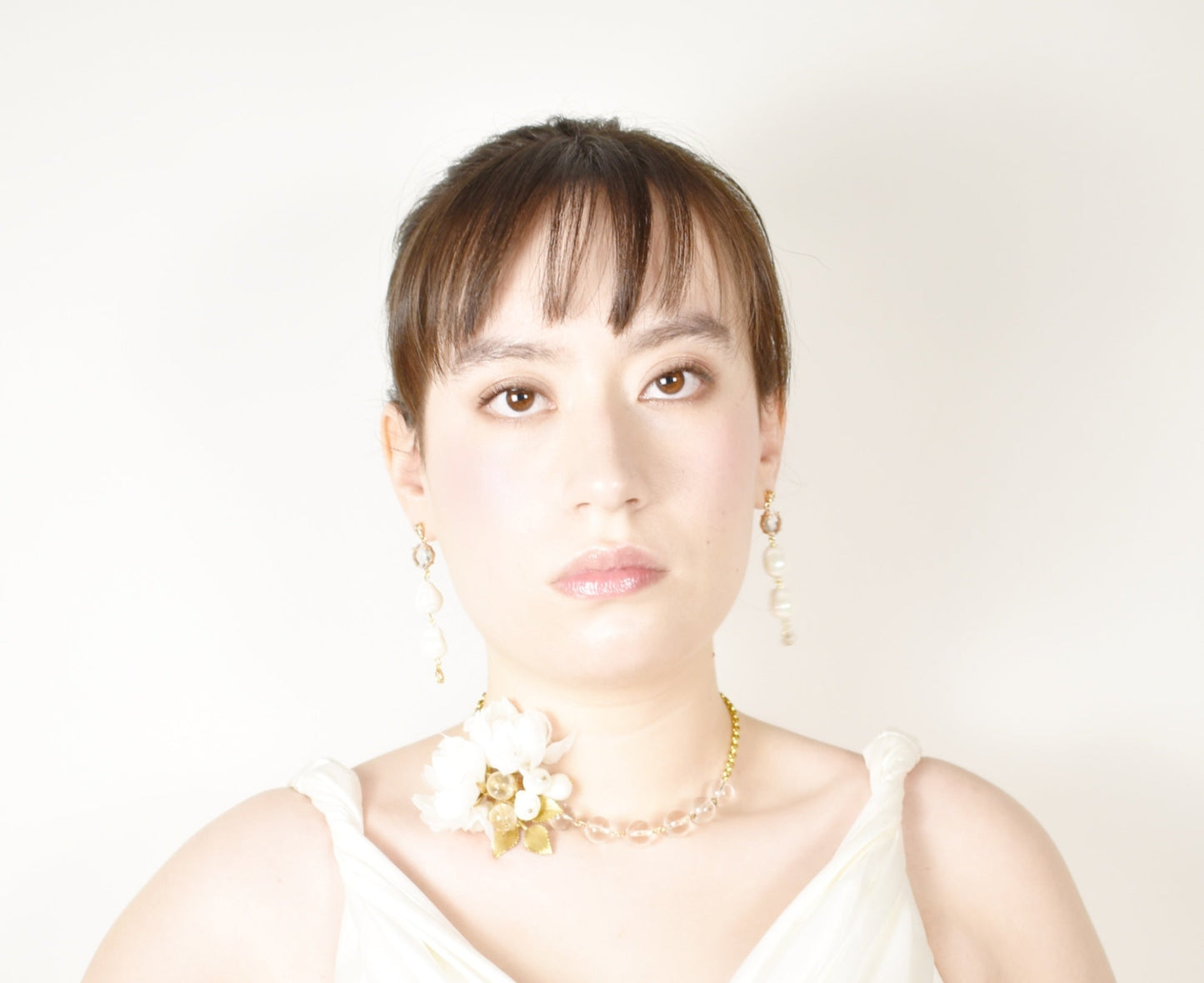 Woman wearing a necklace with a white background